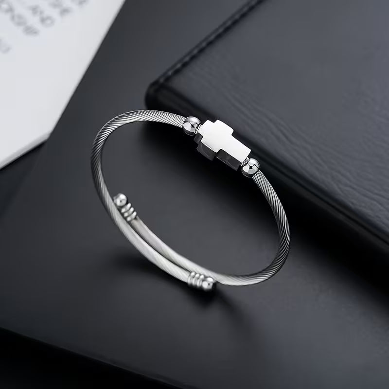 Silver bracelet with a clasp on a dark surface