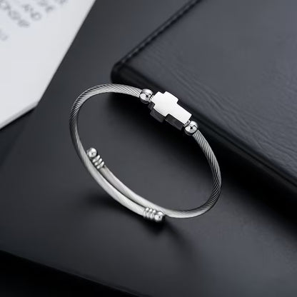 Silver bracelet with a clasp on a dark surface