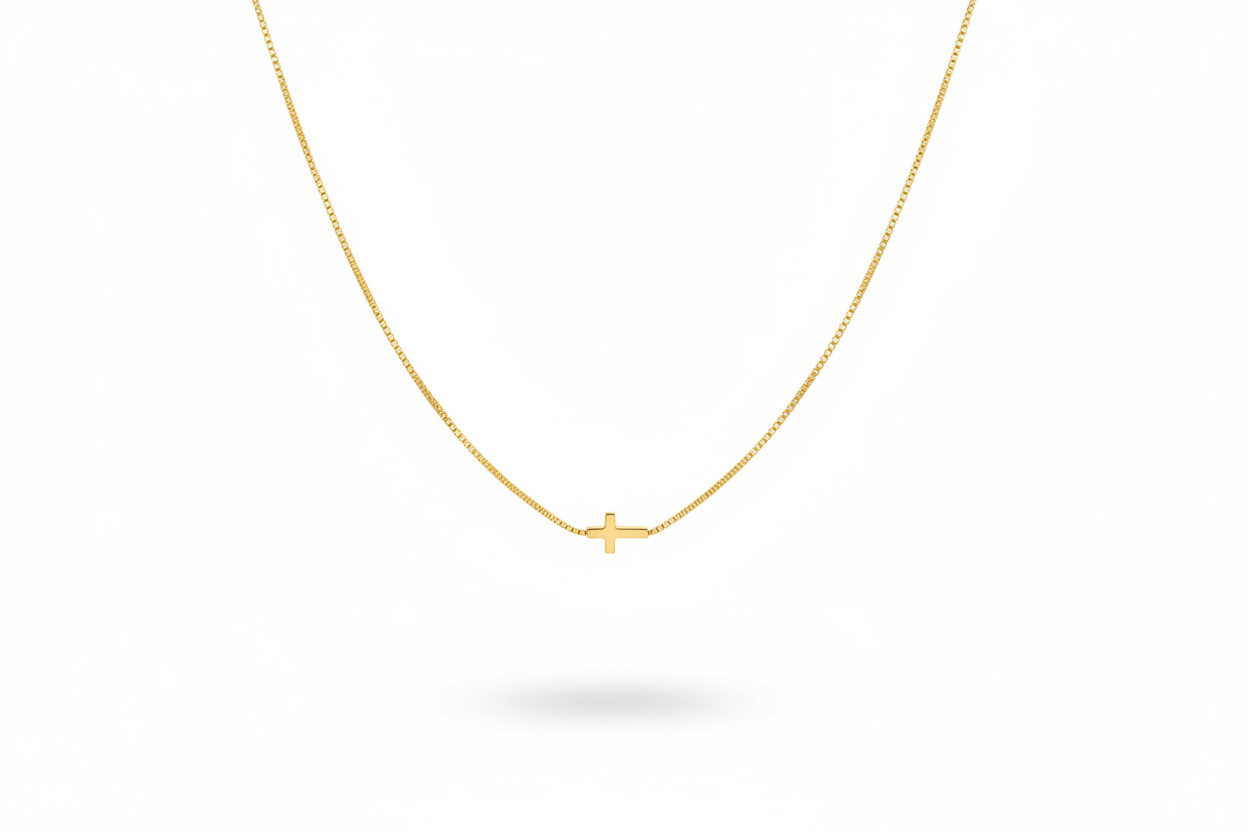Delicate Gold Cross Necklace Hanging on White Background