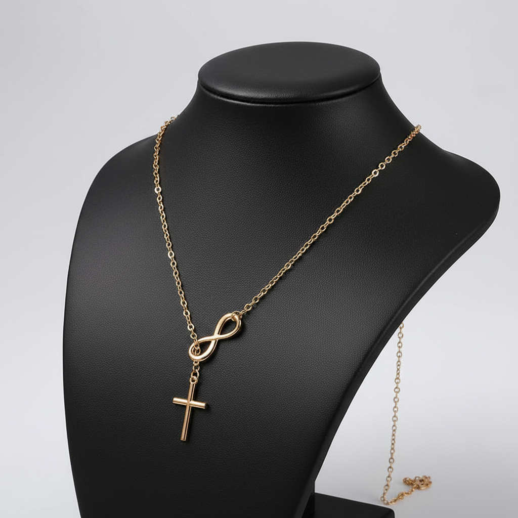 Gold infinity cross necklace side angle on black jewelry bust