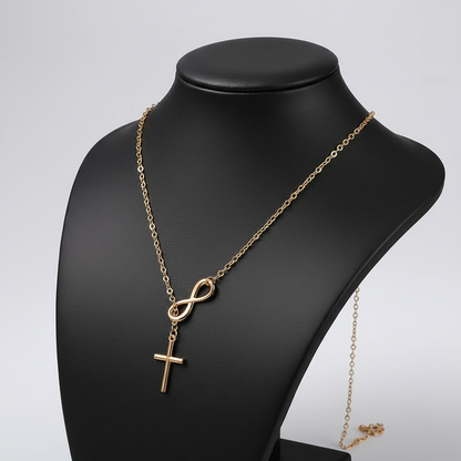 Gold infinity cross necklace side angle on black jewelry bust