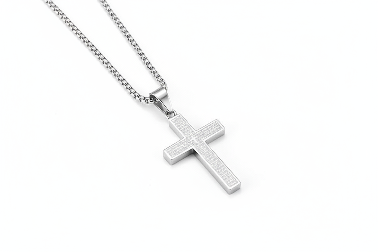 Silver cross necklace on white background