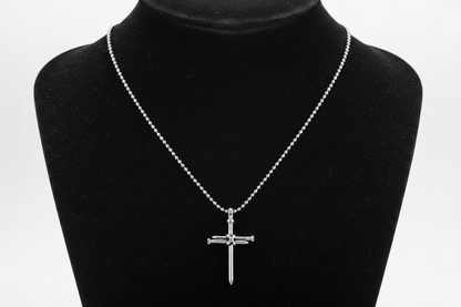 Small Silver Nail Cross Necklace on Black Jewelry Display